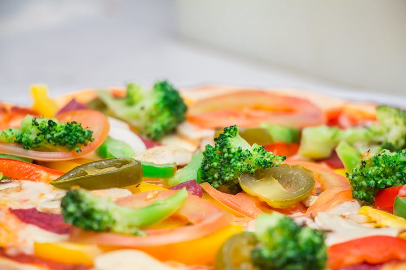 Gourmet pizza slice at round table pizza